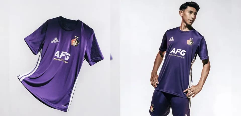 Purple football kit displayed with player wearing it