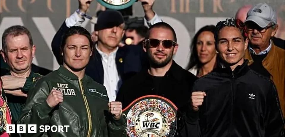 Katie Taylor and opponent posing with championship belts