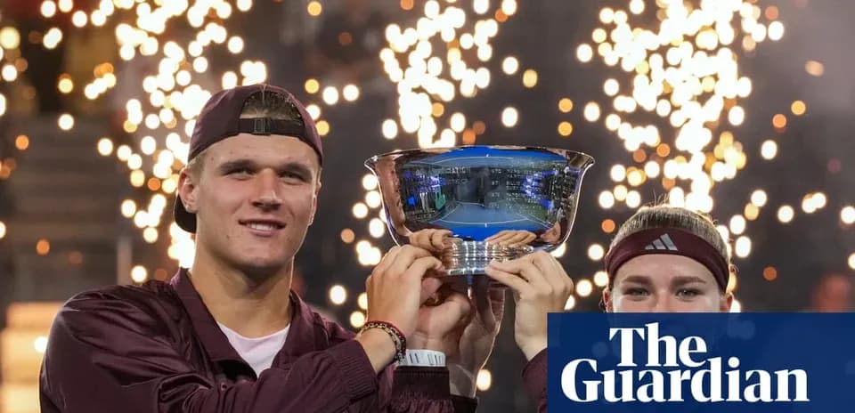 Two players celebrating with trophy and fireworks