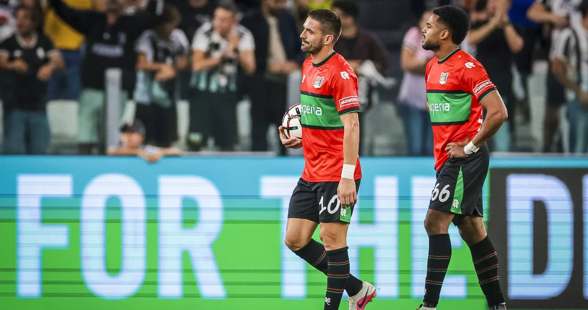 Two players walking off the field after a match