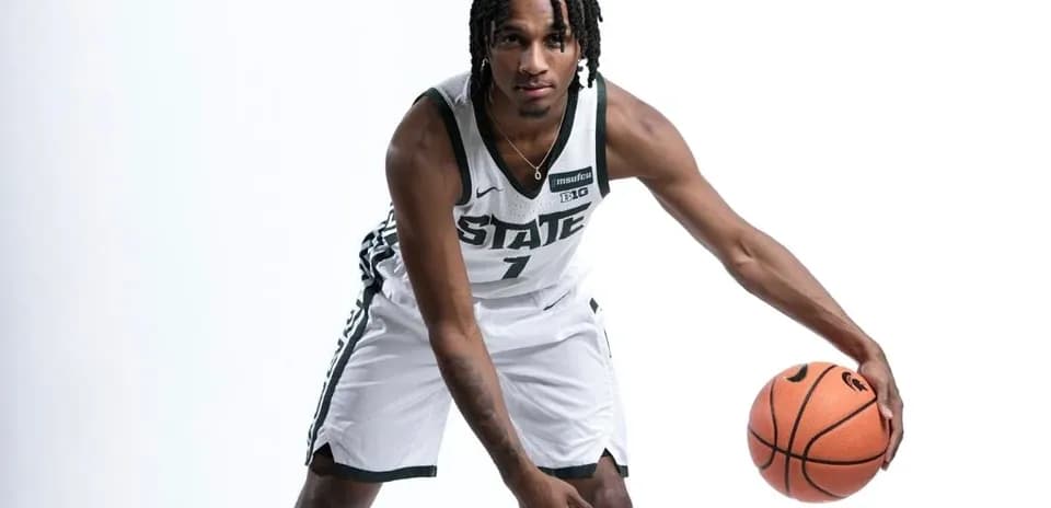 Player dribbling basketball in team uniform