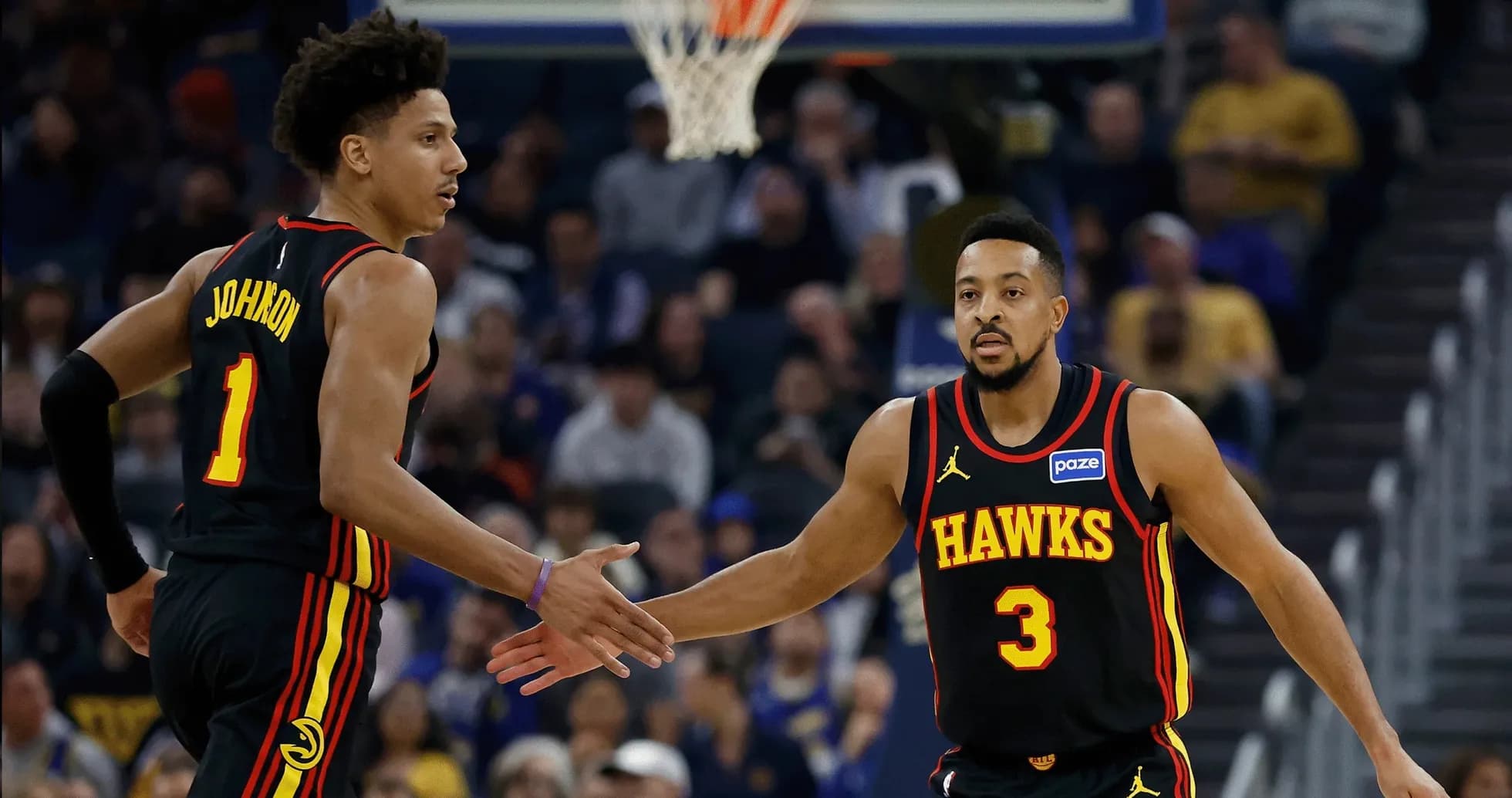 Two Atlanta Hawks players celebrating on the court