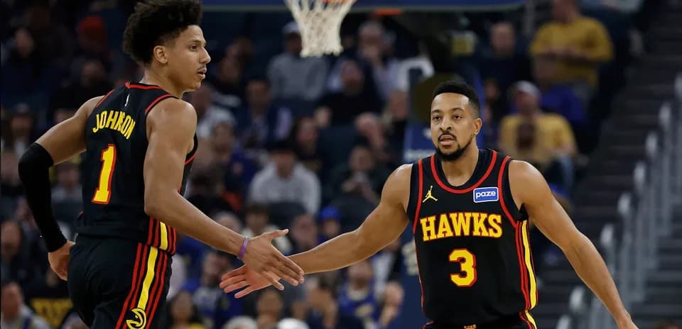 Two Atlanta Hawks players celebrating on the court