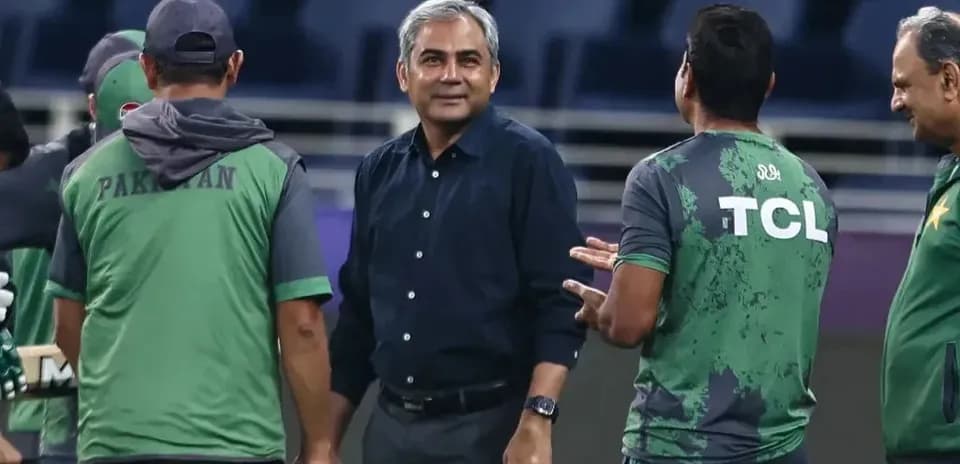 Coaching staff discussing during cricket training session