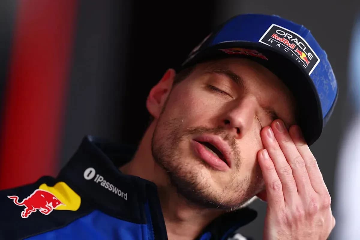 Driver resting hand on face during press conference