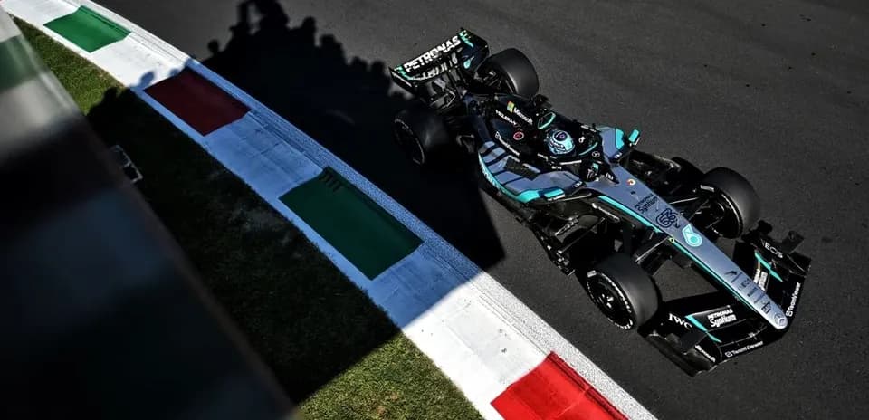 Formula 1 car racing on track near curbs
