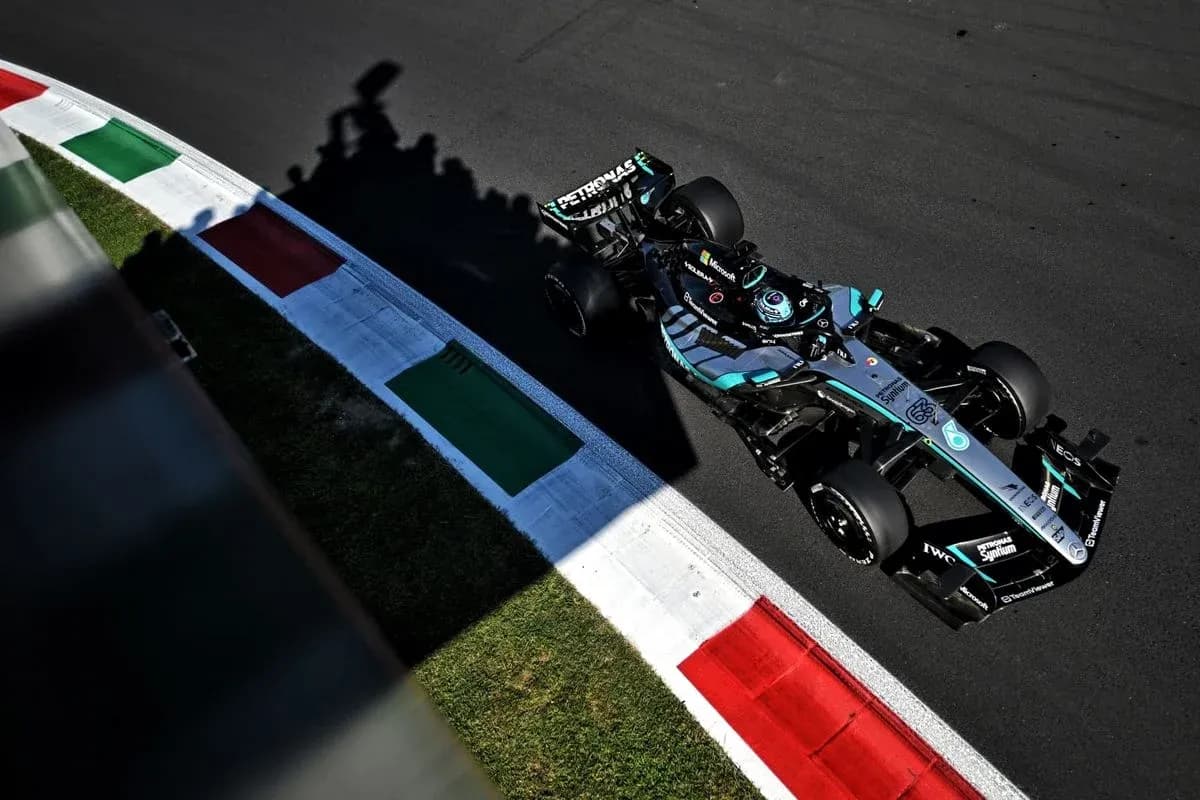 Formula 1 car racing on track near curbs