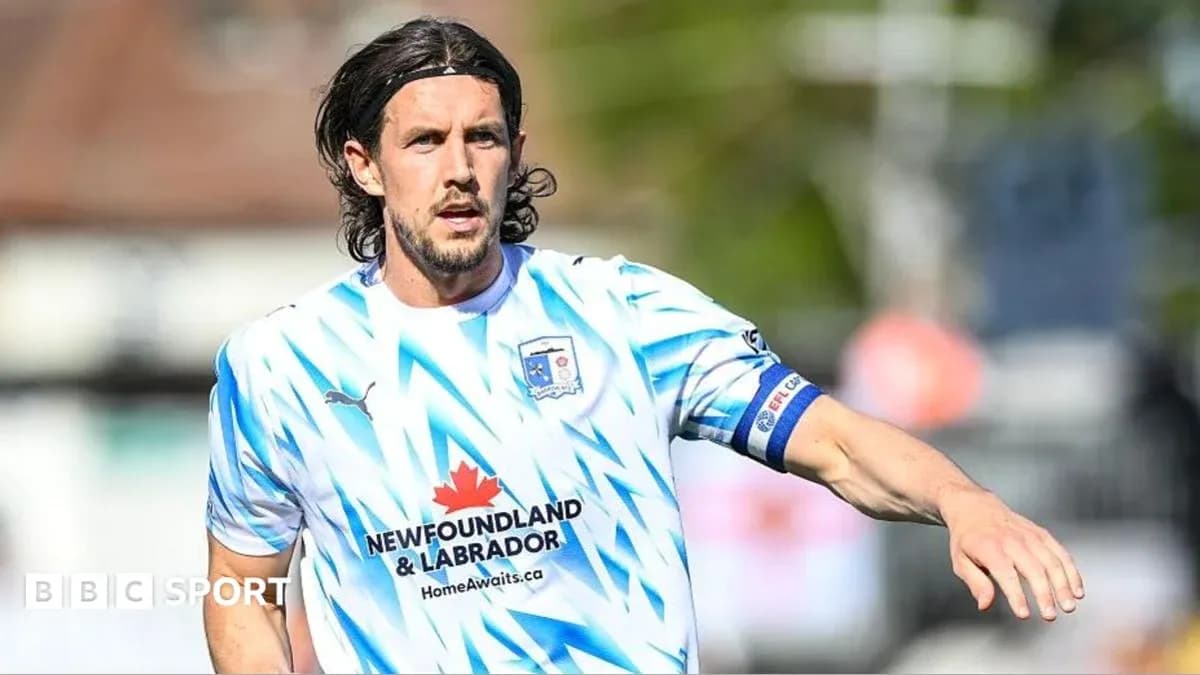 Player in blue and white kit during match Player in blue and white kit during match