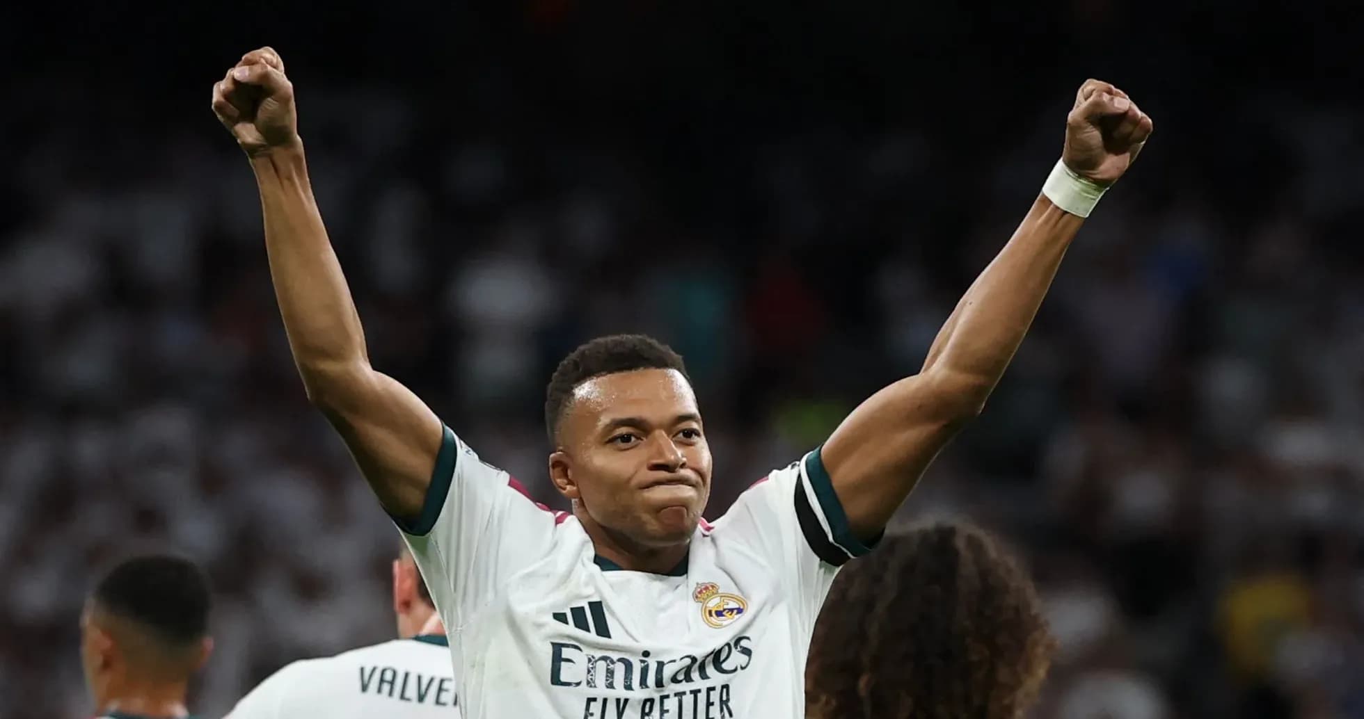 Player celebrating with raised arms on the pitch