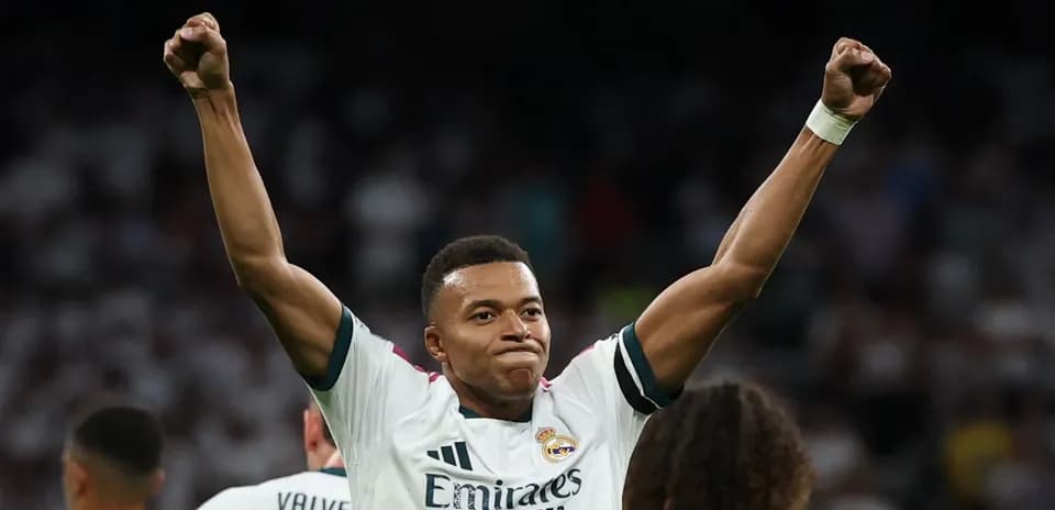 Player celebrating with raised arms on the pitch