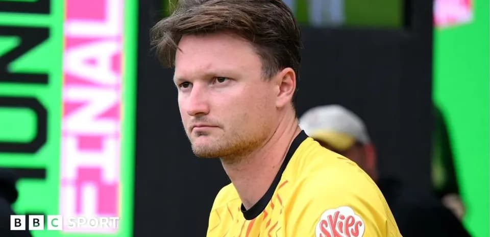 Player in yellow jersey sitting on the bench