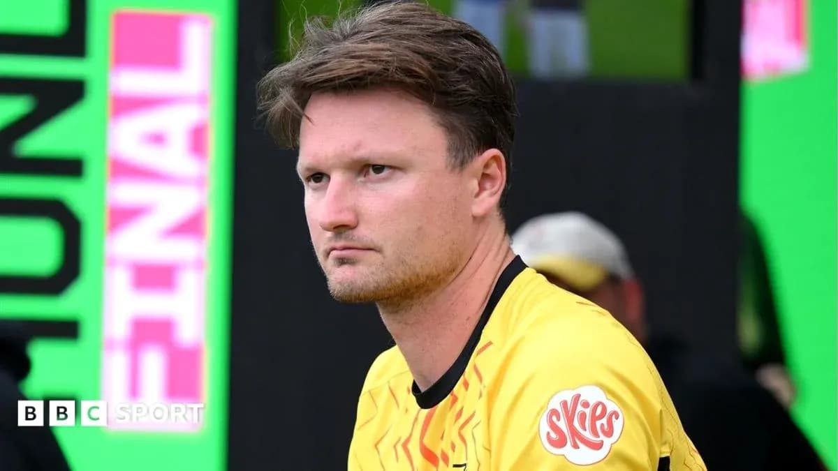 Player in yellow jersey sitting on the bench