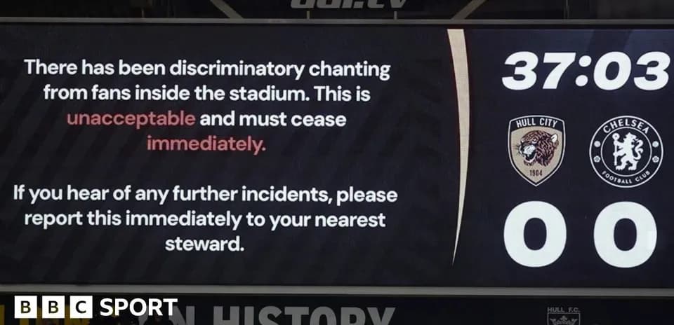 Scoreboard displaying warning about discriminatory chanting
