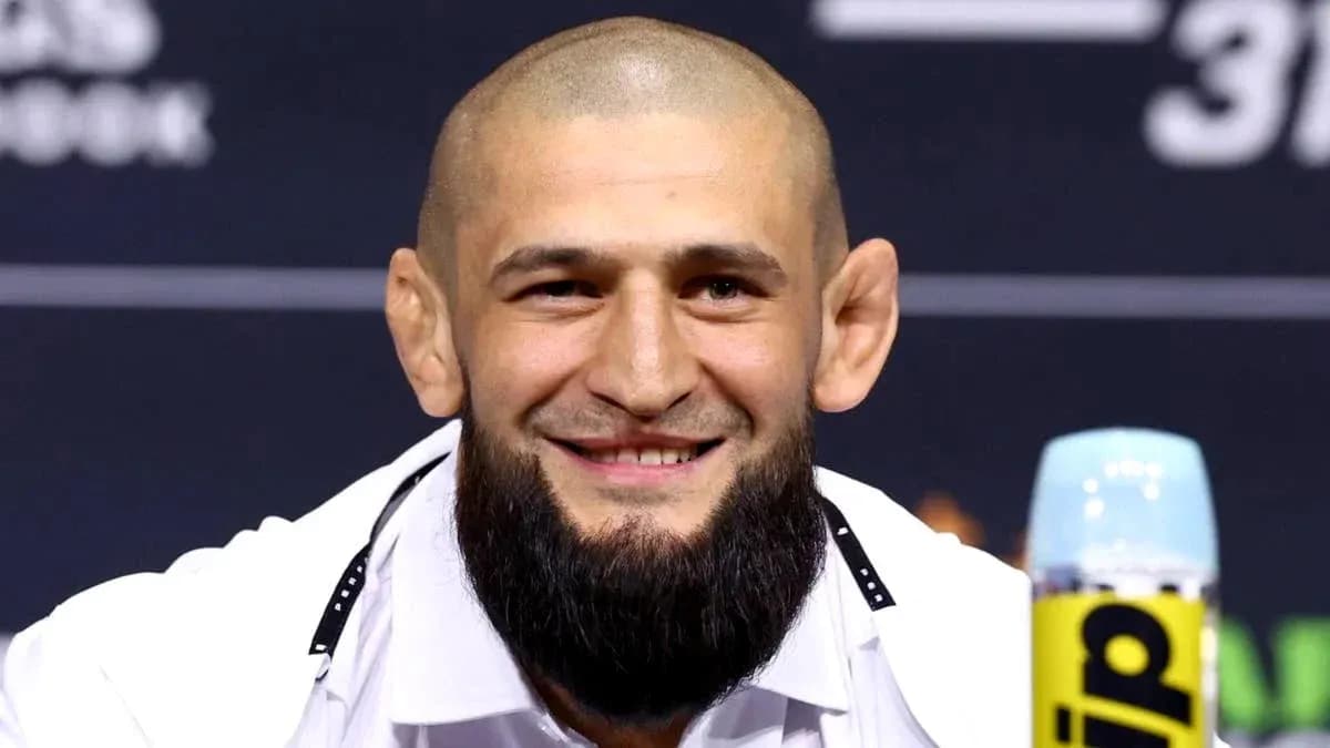 Fighter smiling at press conference with microphone
