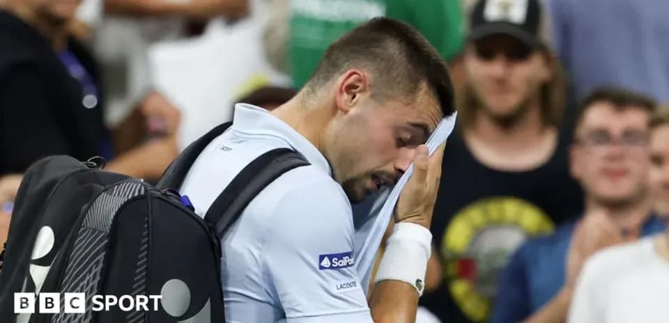 Player wiping face with towel during match