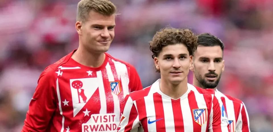 Atletico Madrid players in warm-up jerseys on pitch