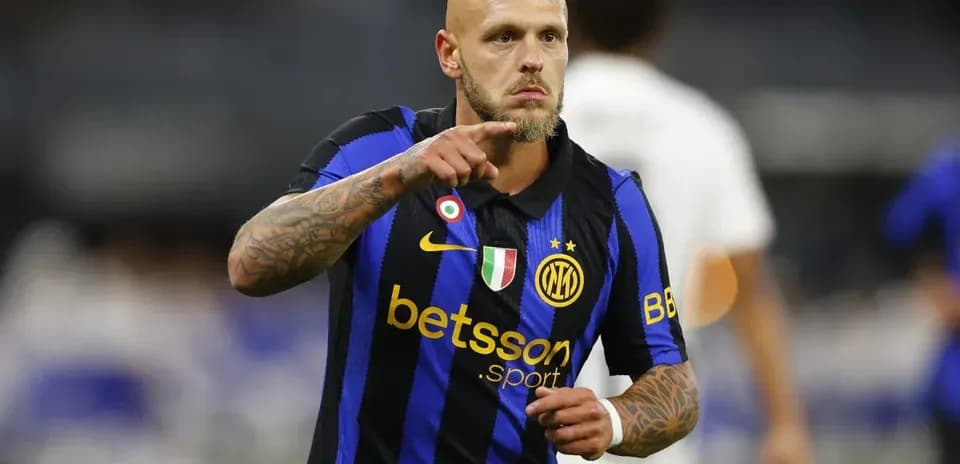 Player in blue and black jersey signaling during match