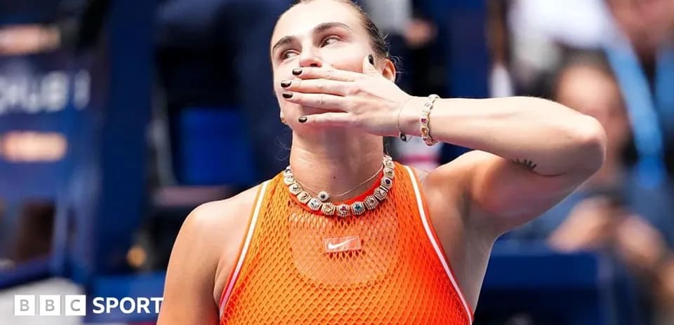 Tennis player celebrating with hand gesture after match