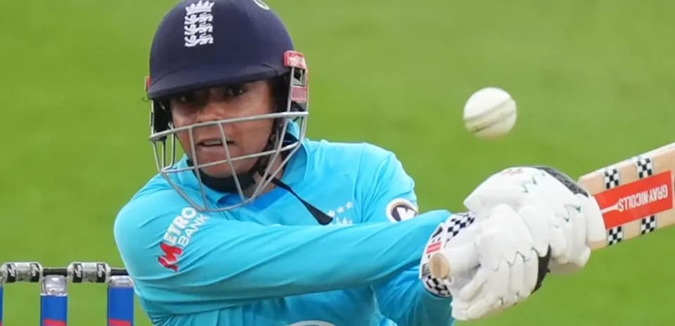 Cricketer batting while facing a delivery