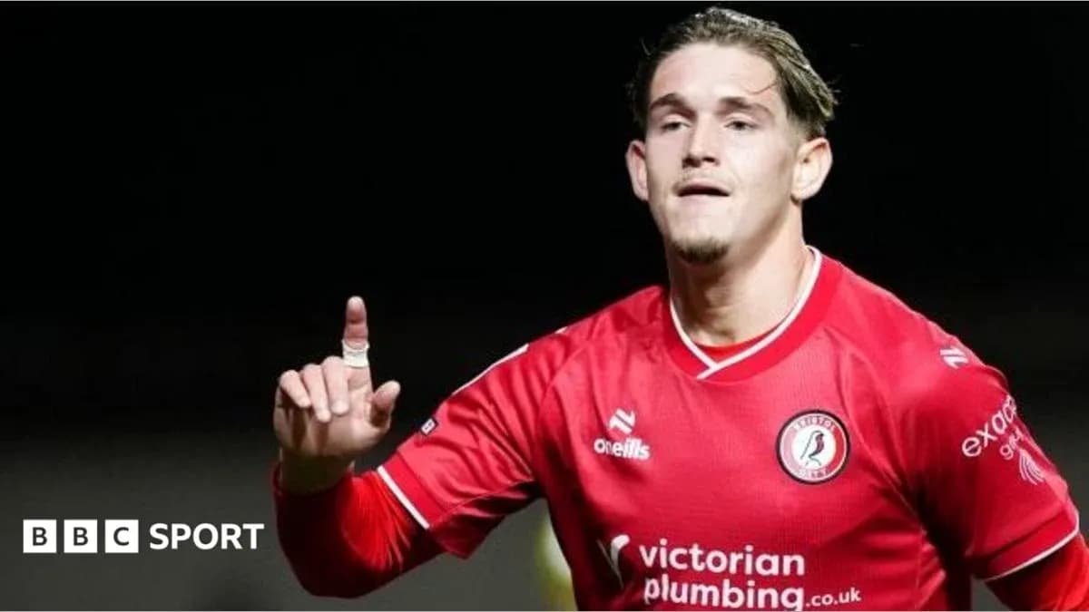 Player celebrating after scoring a goal in red jersey