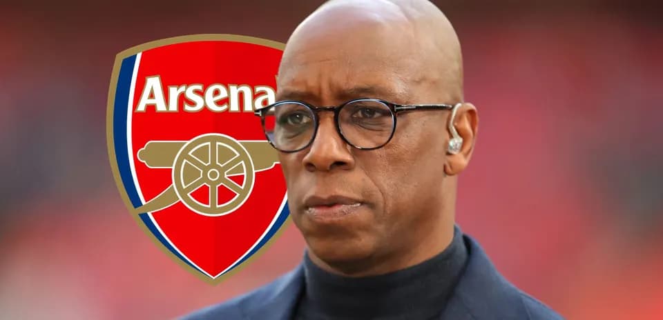 Man with glasses in front of Arsenal logo