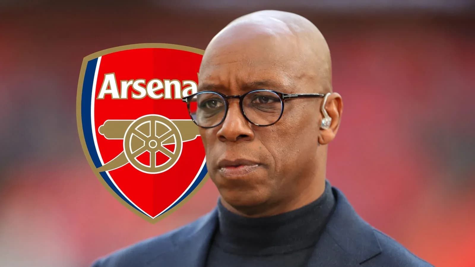 Man with glasses in front of Arsenal logo