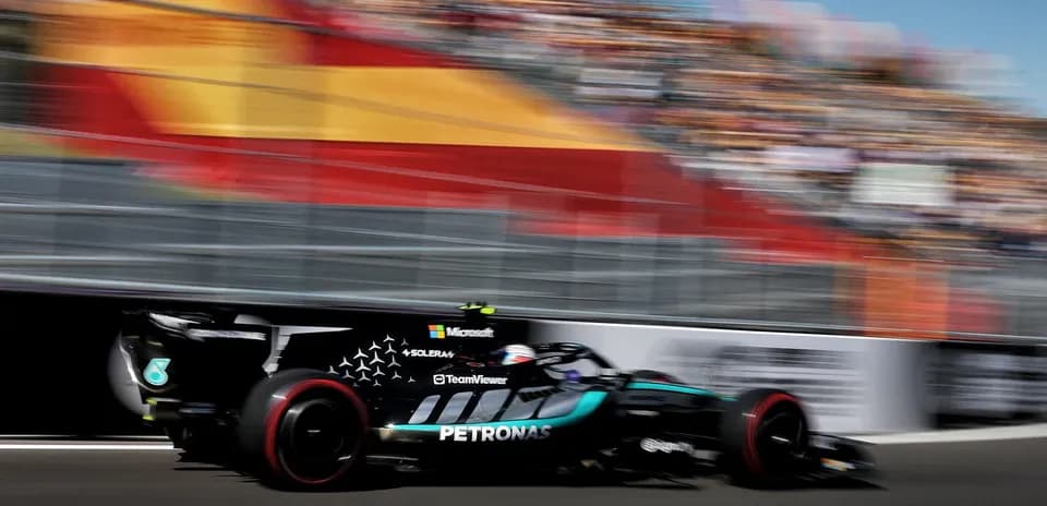 Formula 1 car racing past grandstand during event