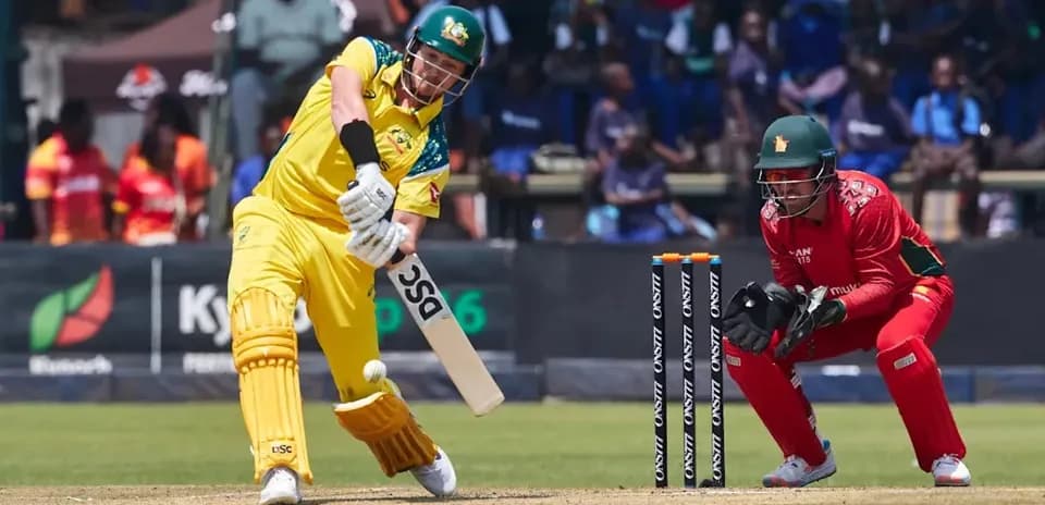 Batsman hitting the ball with wicketkeeper behind