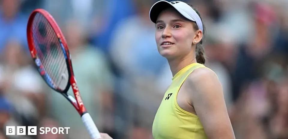 Tennis player smiling while holding a racket