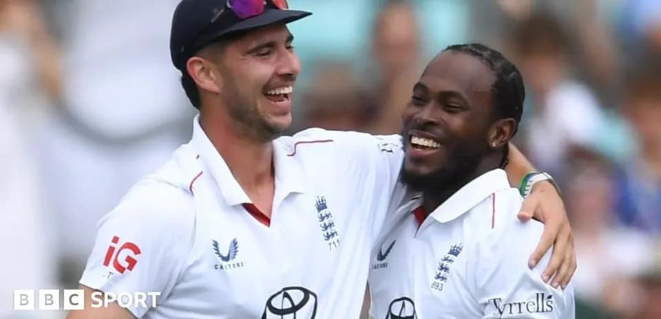 Two cricket players celebrating on the field