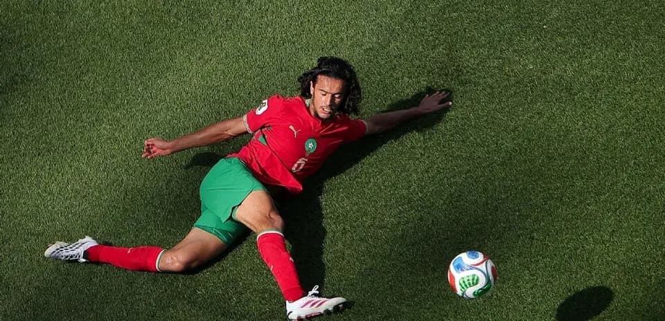 Player in red and green uniform on the ground