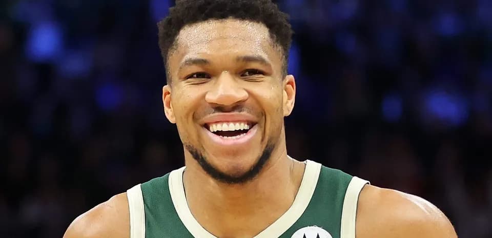 Player smiling in Milwaukee Bucks jersey