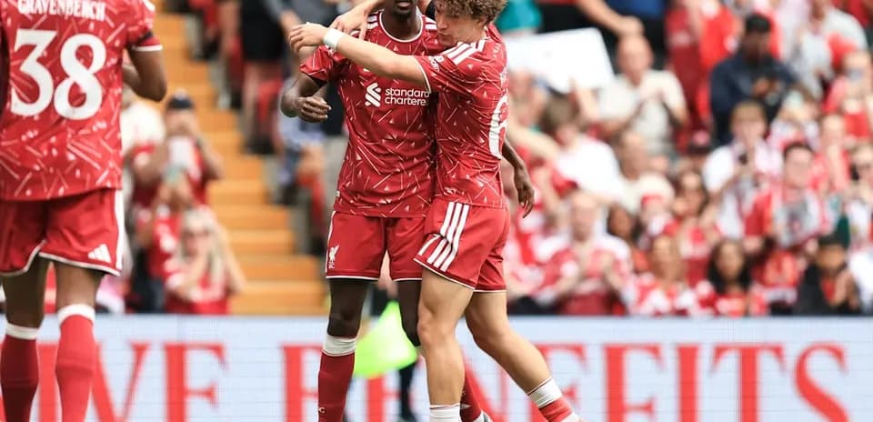 Two Liverpool players celebrating on the field