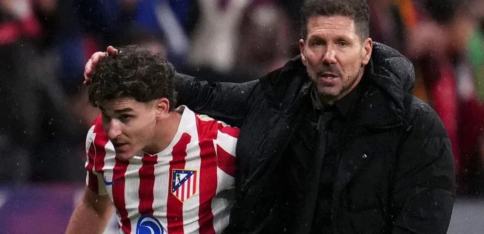 Atletico Madrid player and coach on the sidelines