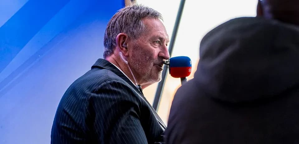 Sportscaster speaking into microphone during broadcast
