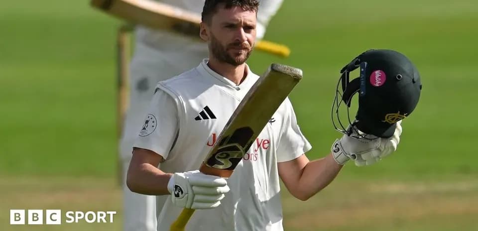 Batsman raising bat and helmet after innings