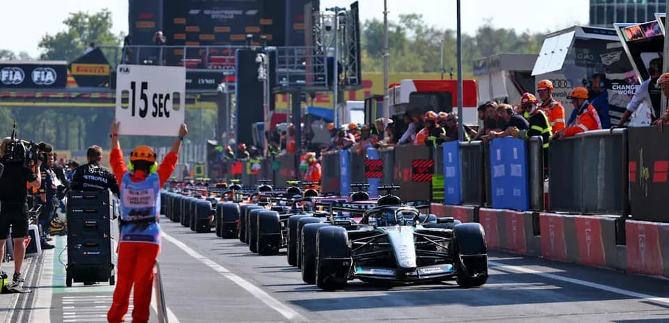 Cars in pit lane with 15-second penalty sign