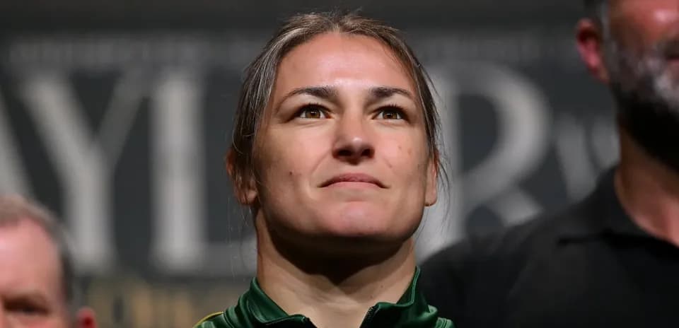 Athlete at a press event, wearing green jacket
