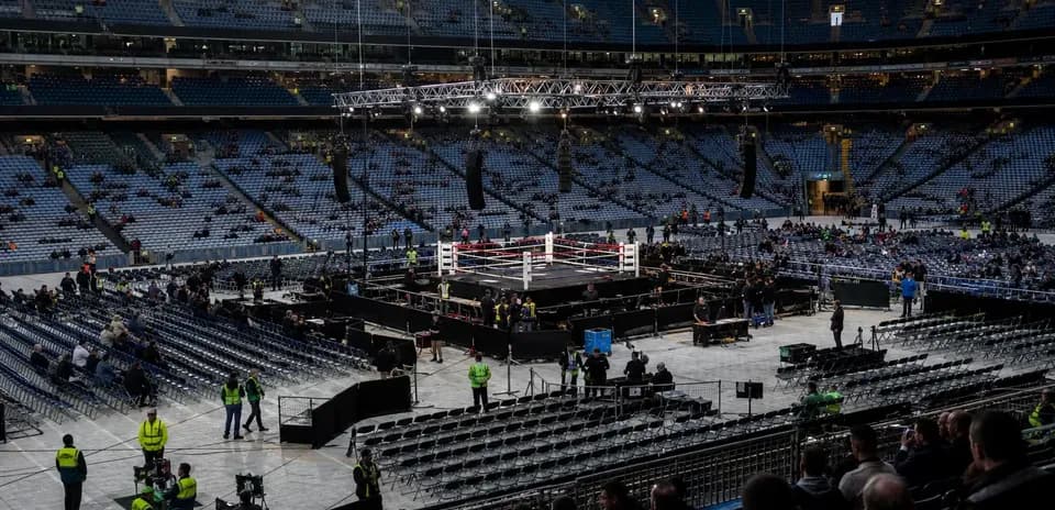Empty boxing ring set up in large stadium