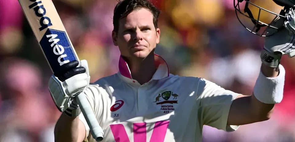Cricketer celebrating century with raised bat