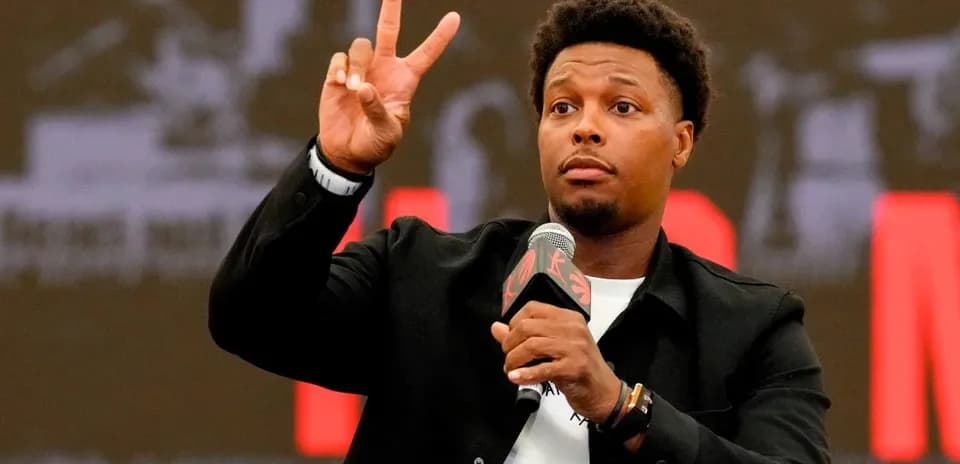 Player gesturing with peace sign at podium