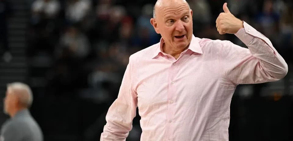 Man gesturing during basketball game on sidelines