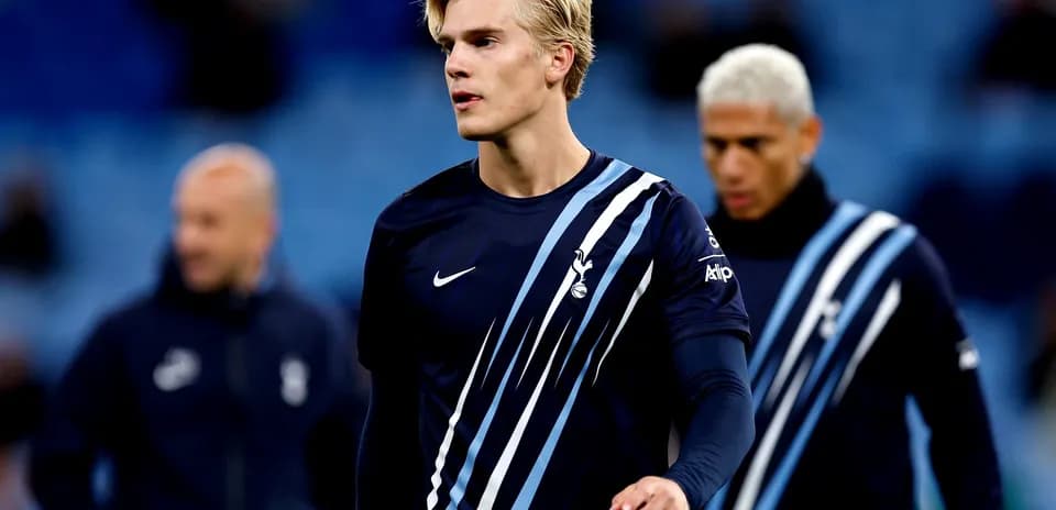 Player walking on pitch in Tottenham training gear