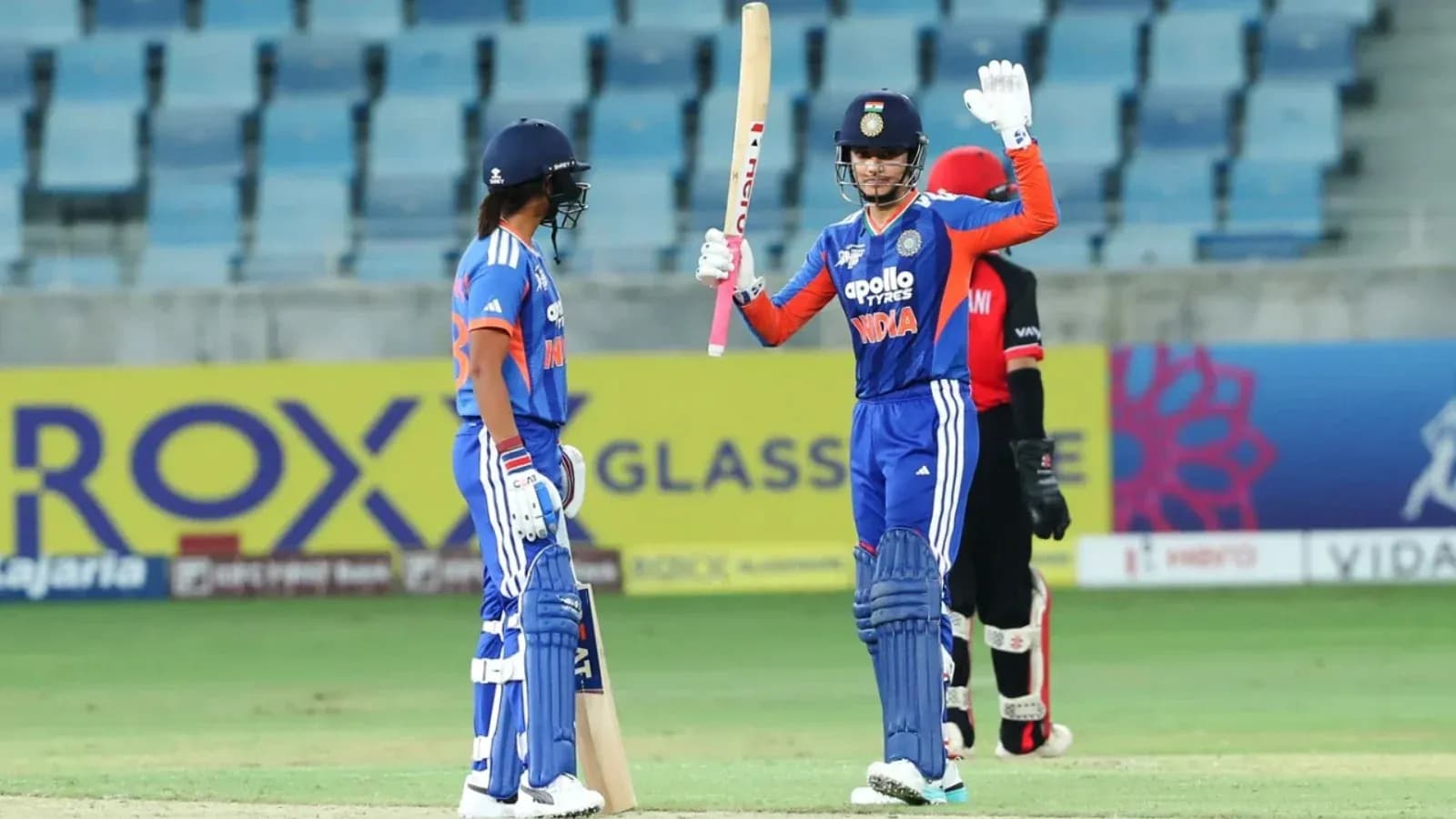 Batsman celebrating a boundary during cricket match