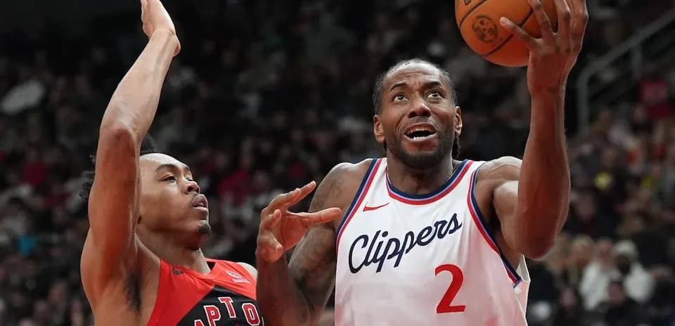 Kawhi Leonard shooting while guarded by opponent