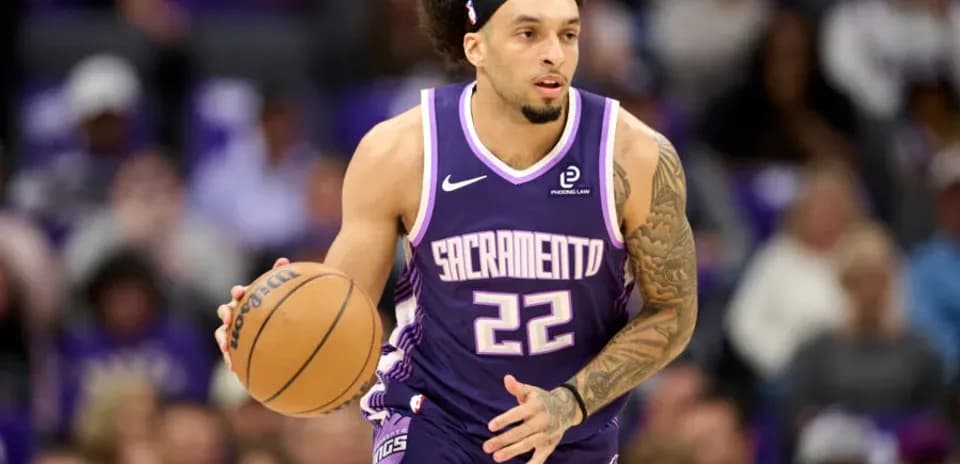 Player dribbling basketball during game for Sacramento Kings