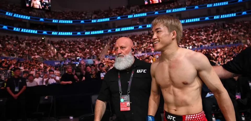 Fighter Kai Asakura entering arena with coach