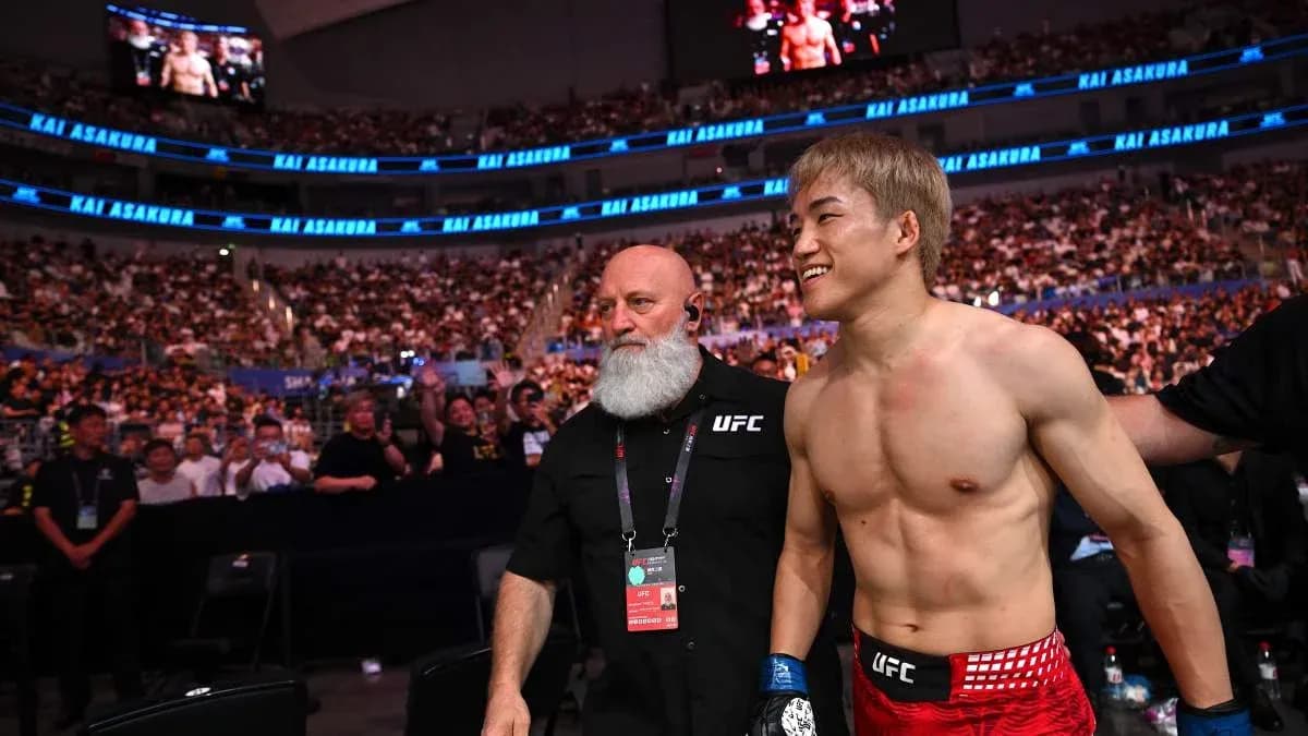 Fighter Kai Asakura entering arena with coach