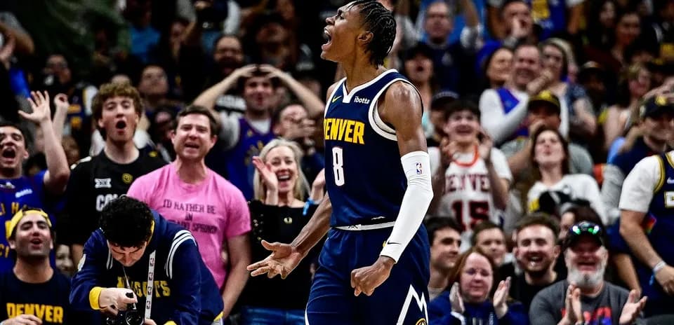 Denver player celebrating with enthusiastic crowd behind