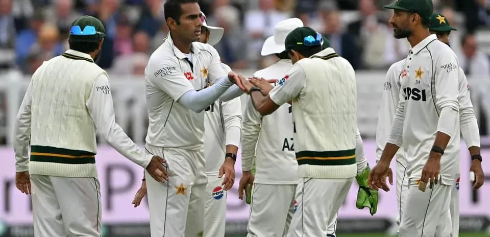 Pakistani cricketers celebrating a wicket on field